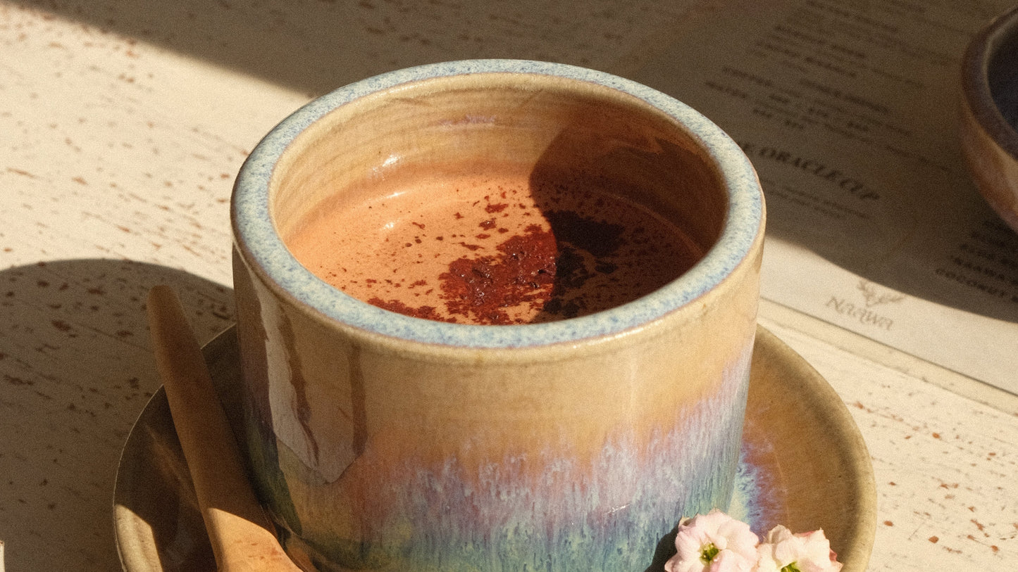 Ceramic vase with a rainbow gradient on a textured surface